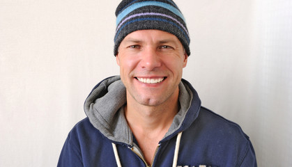 Portrait of the smiling man wearing a knitted hat