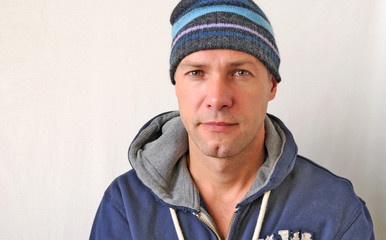 Portrait of the smiling man wearing a knitted hat