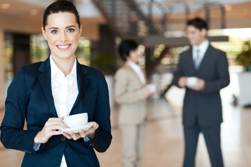 beautiful young businesswoman having coffee break