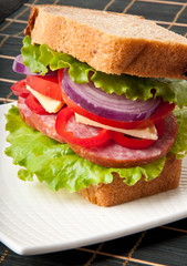 Healthy ham sandwich with cheese, tomatoes and lettuce
