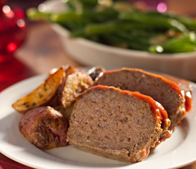 Fototapeta na wymiar Meat loaf with roasted herb potatoes