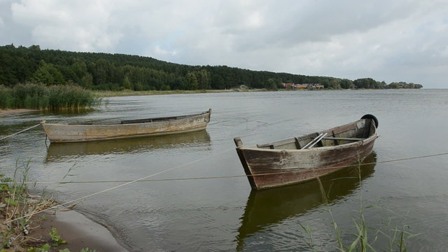 two wooden boats near sea coast
