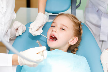 Fototapeta premium Little girl visiting dentist