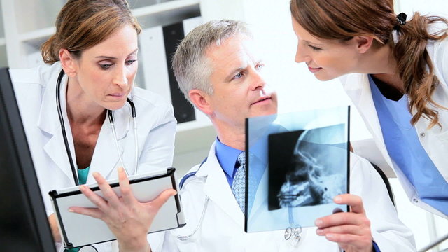 Caucasian Doctors Checking X- Ray Film