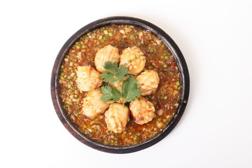 spicy fried squid balls cooking in a pan