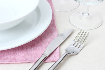 Table setting with fork, knife, plates and napkin
