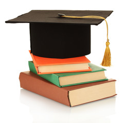 Grad hat with books isolated on white