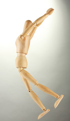 wooden mannequin, on grey background