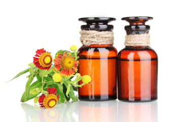 medicine bottles and flowers isolated on white