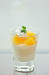 cup of orange panna cotta on the table