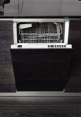Open dish washer machine on black hardwood kitchen