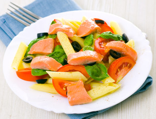 Pasta salad with tomatoes, basil leaves and fish