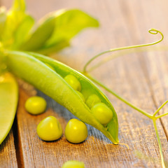 Fresh peas pods on a wooden table