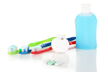 Toothbrush, chewing gum and dental floss isolated on white