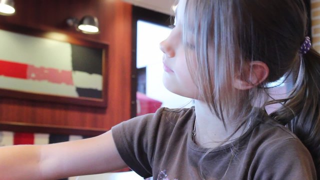 Child eating a roasted potatoes, french fried chips