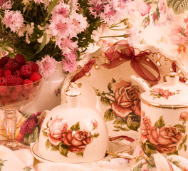 Vintage tea in elegant tableware, raspberry and flowers