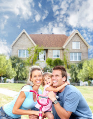 Happy family near new house.