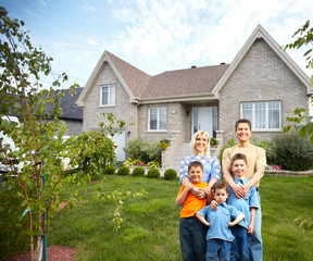 Happy family near new house.