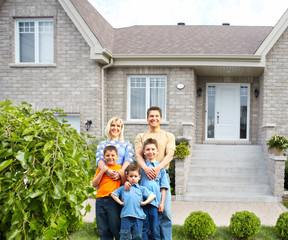 Happy family near new house.