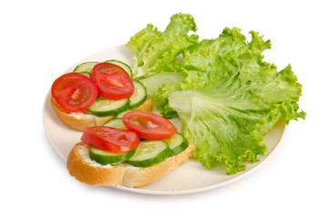 Tomatoes and cucumbers on white