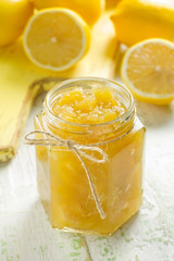Fototapeta na wymiar Homemade lemon jam in a glass jar and fresh fruits