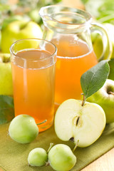Apple juice and fresh fruits with leaves