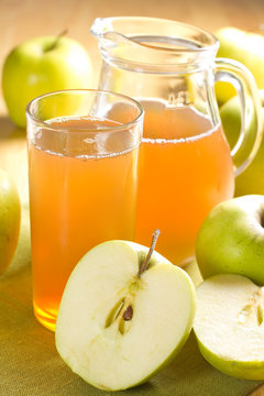 Apple juice and fresh fruits with leaves