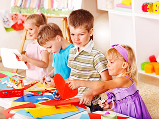Child cutting out scissors paper.