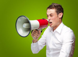 Portrait Of Young Man Shouting On Megaphone