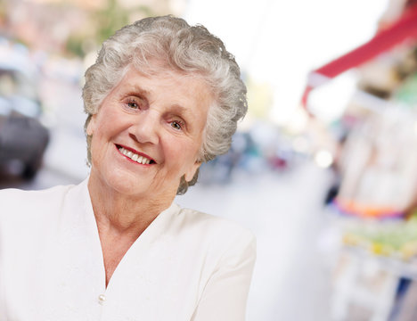 portrait of a adorable senior woman standing at street