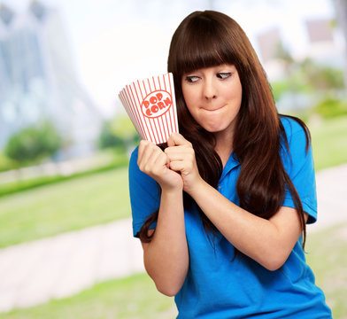 girl holding empty popcorn packet