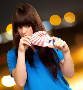 girl looking through empty popcorn packet