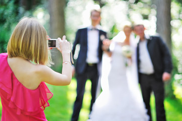 Girl photographing guests at the feast