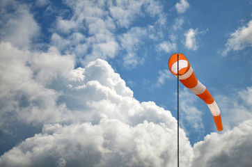 Windsock against blue sky and clouds