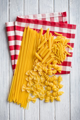 various raw pasta on kitchen table