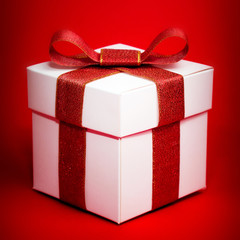 White box with a red ribbon on red background
