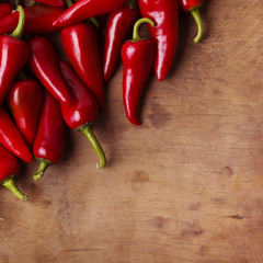 Red hot chili peppers on old wooden table