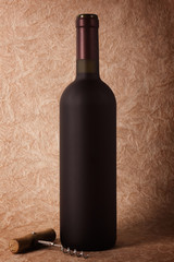 wine bottle and corkscrew on a paper background