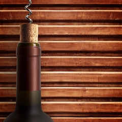 corkscrew and bottle of wine on the board