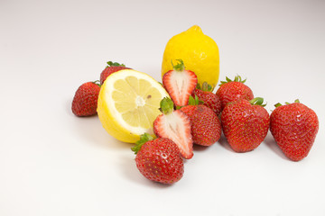 Fototapeta na wymiar Lemon and strawberries on white