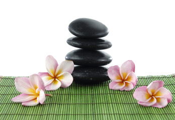 four frangipani flower with zen atones on mat