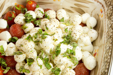 Mozarella salad in bowl on white