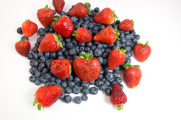 Strawberries and blueberries on white
