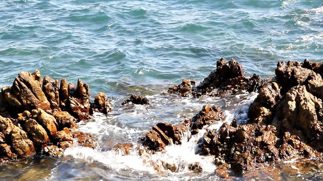 Sea waves slide to stones