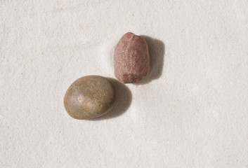 two stones lying on the sand