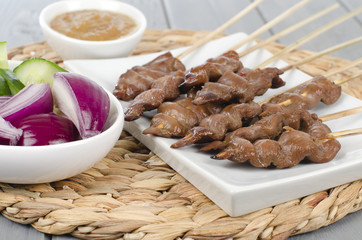 Duck Satay served with peanut sauce, red onions and cucumber.