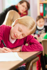 Schulkinder und Lehrerin lernen an der Schule