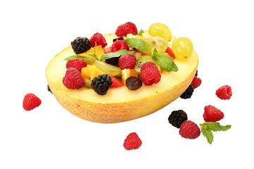 fresh fruits salad in melon  and berries, isolated on white