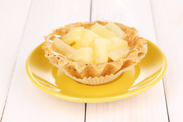 sweet cake with fruits on wooden background