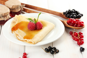 Delicious pancake with berries and honey